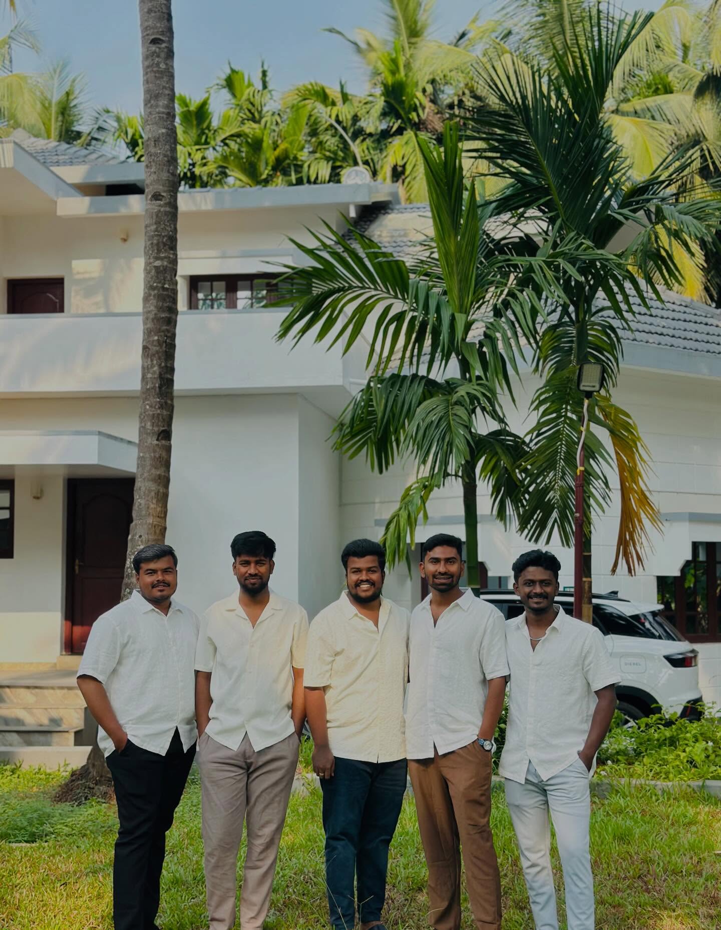 Family enjoying the outdoor green garden at Konkan Kuteera riverside homestay